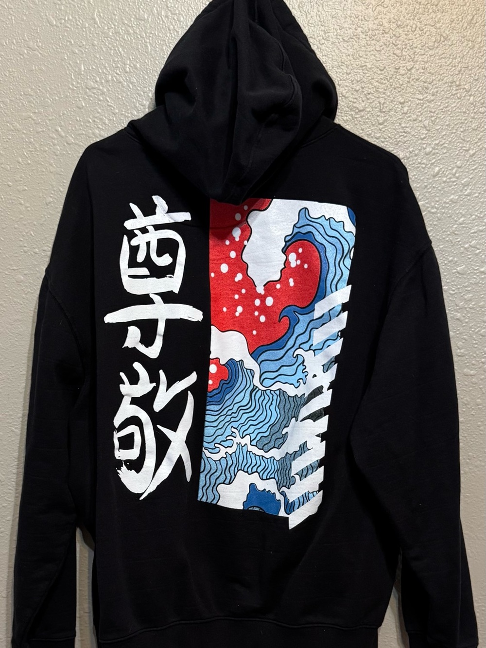 Black Graphic Pullover Hoodie with Red & Blue Wave Panel
